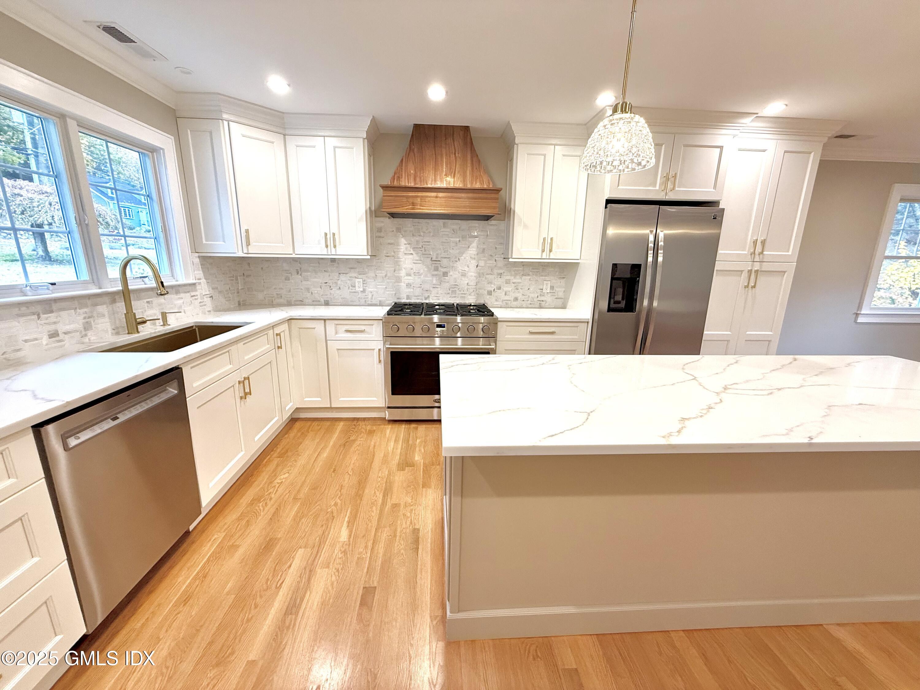 79 Laddins Rock Road Old Greenwich, CT 06870 - Photo 6 of 26 a kitchen with kitchen island granite countertop a sink a counter top space stainless steel appliances and cabinets