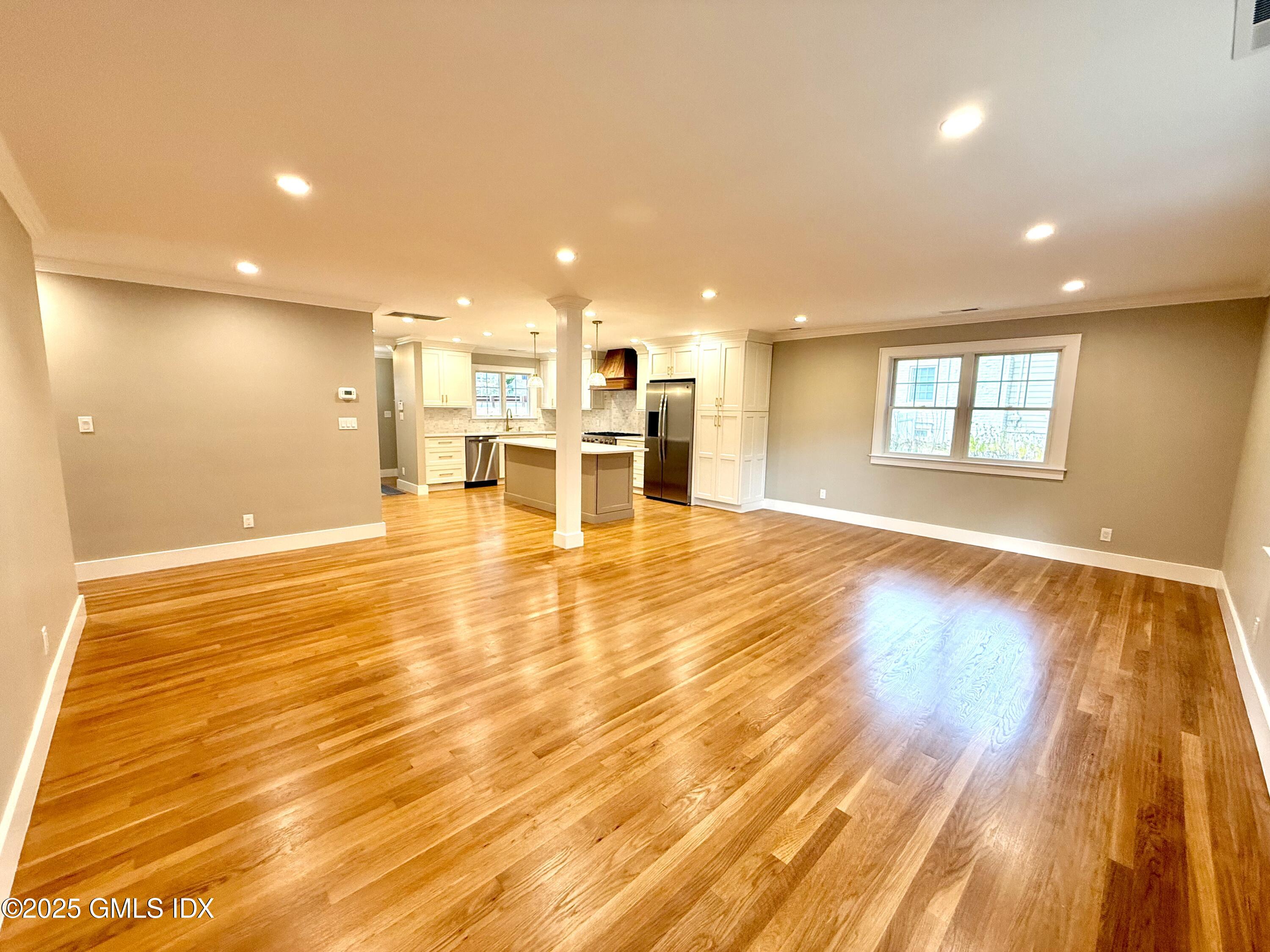79 Laddins Rock Road Old Greenwich, CT 06870 - Photo 8 of 26 a view of a living room a dining room with wooden floor and a window