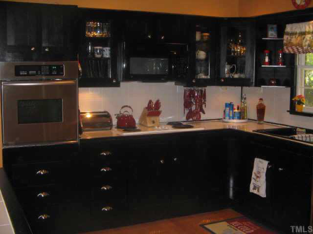 420 Crescent Raleigh Nc 27609 Raleigh, NC 27609 - Photo 6 of 10 a kitchen with a sink and cabinets