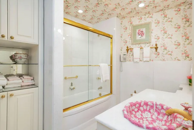 a bathroom with a bathtub and shower