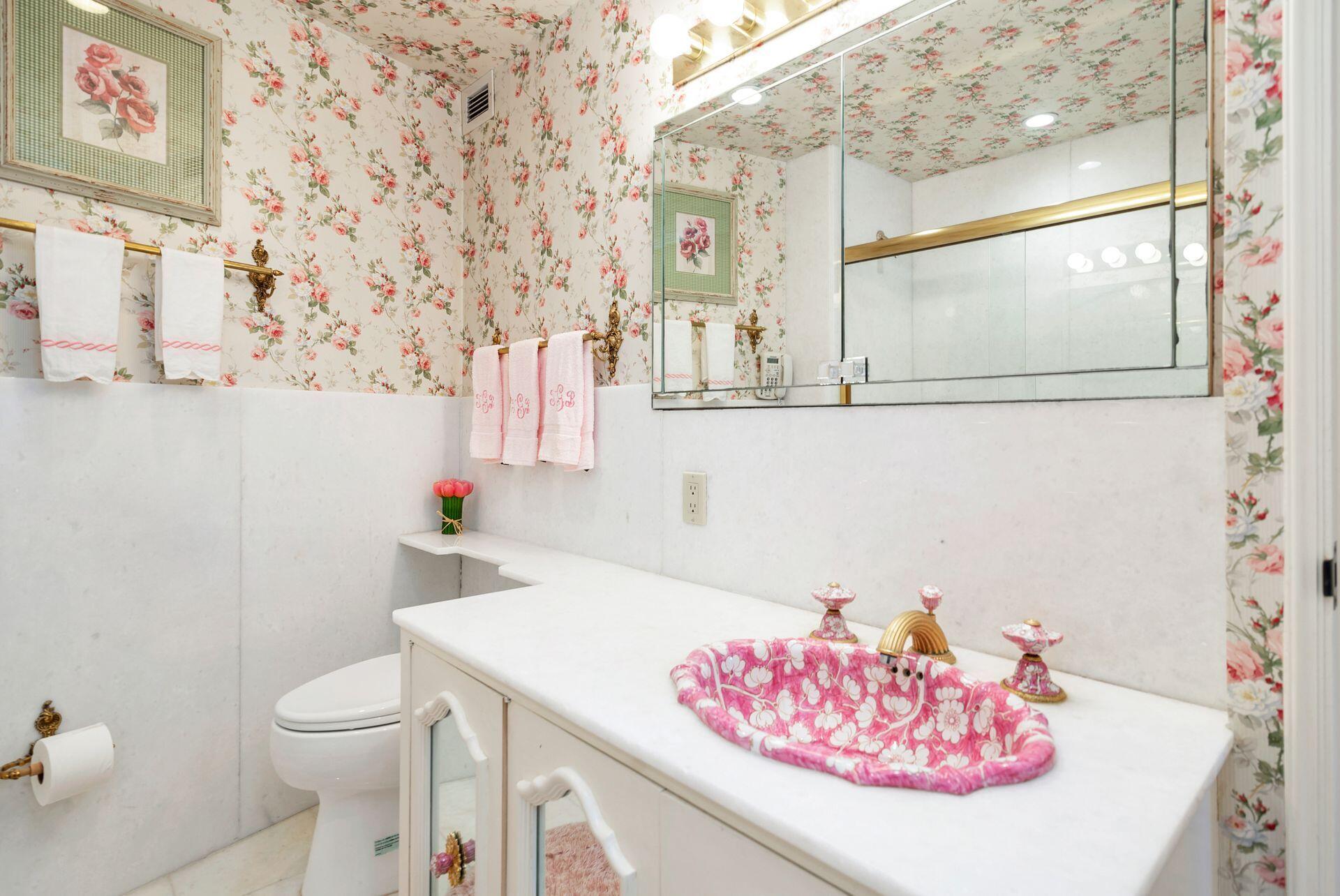 44 Cocoanut Row, Unit 227B Palm Beach, FL 33480 - Photo 19 of 28 a bathroom with a sink a toilet and a mirror