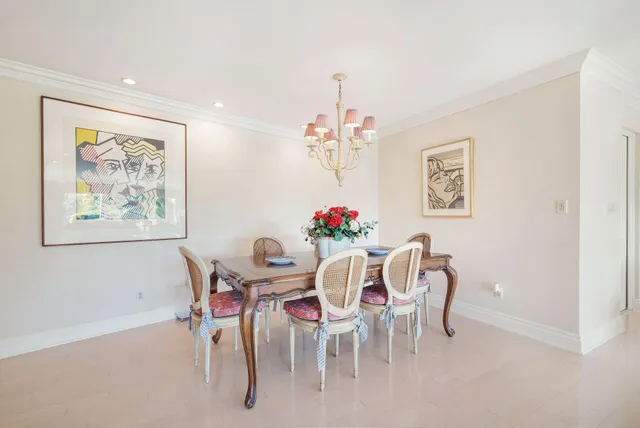 a view of a dining room with furniture and a chandelier