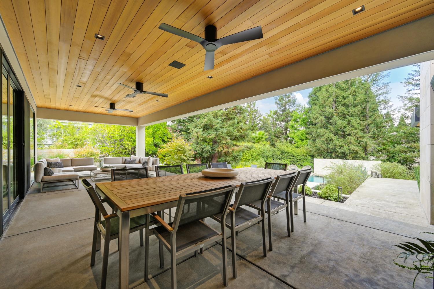 5020 Manchester Court Granite Bay, CA 95746 - Photo 62 of 95 a view of a patio with table and chairs and floor to ceiling window with wooden floor