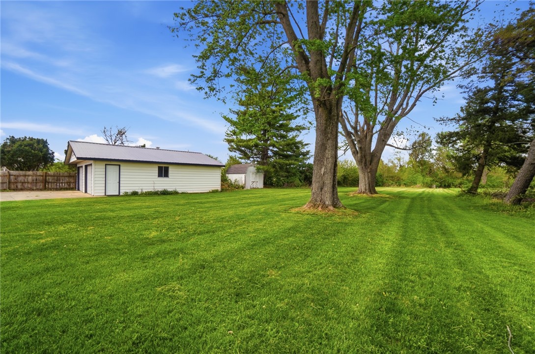 3991 Benner Road Miamisburg, OH 45342 - Photo 35 of 44 Expansive green yard with mature trees, offering a serene outdoor environment.
