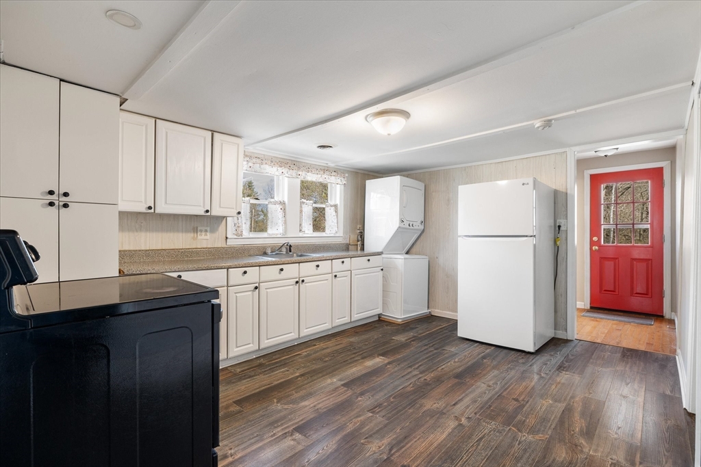 113 Baldwinville Road Templeton, MA 01468 - Photo 7 of 24 a kitchen with stainless steel appliances granite countertop a refrigerator a sink dishwasher a stove with white cabinets and wooden floor