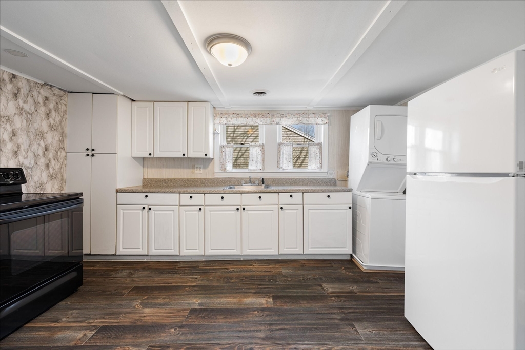 113 Baldwinville Road Templeton, MA 01468 - Photo 9 of 24 a kitchen with granite countertop white cabinets and refrigerator