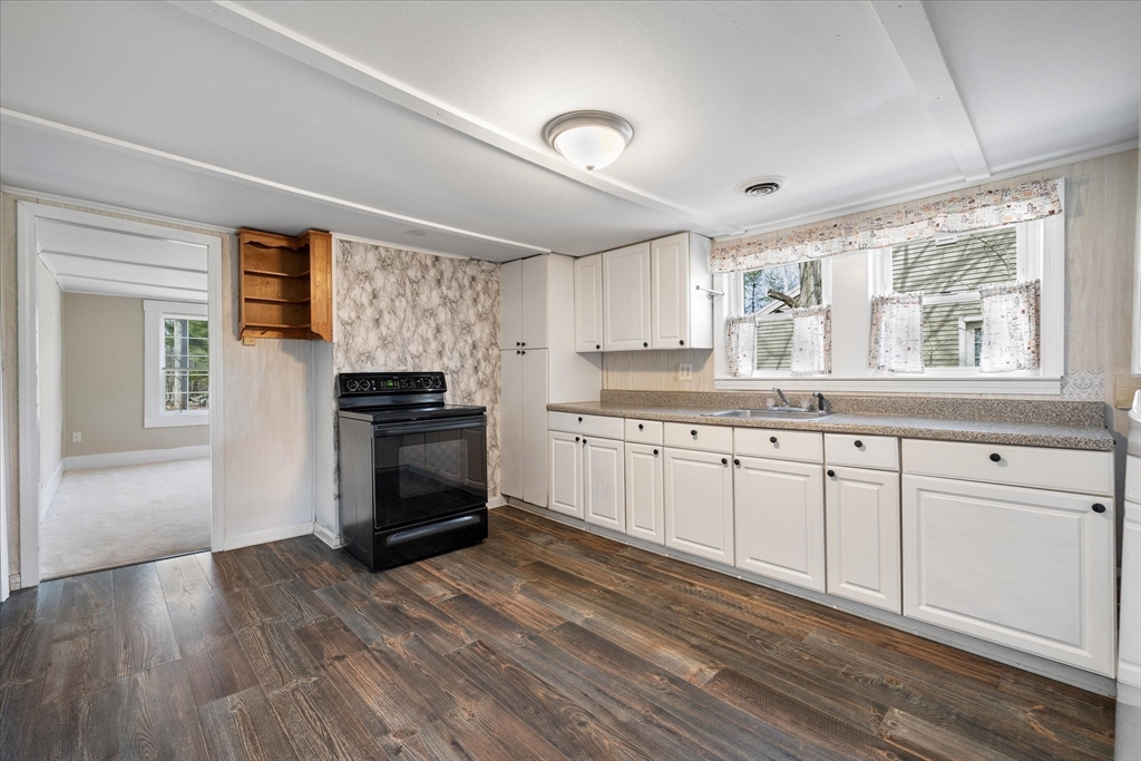 113 Baldwinville Road Templeton, MA 01468 - Photo 10 of 24 a kitchen with granite countertop white cabinets and white appliances