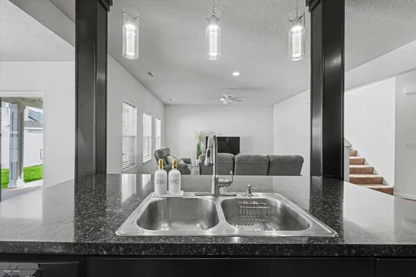 a kitchen with kitchen island granite countertop a sink and a granite counter top