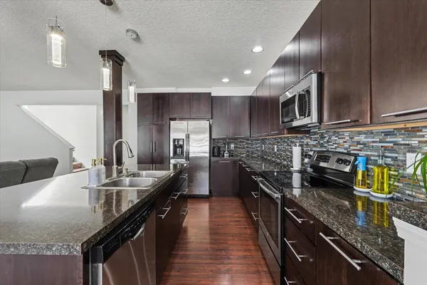 a kitchen with stainless steel appliances granite countertop counter space a sink and cabinets