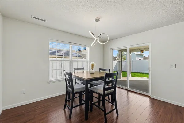 a view of a dining room with furniture window and wooden floor