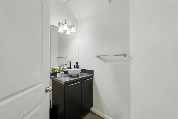 a view of a bathroom with a sink and a mirror