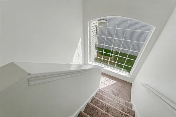 a view of room with window and wooden floor