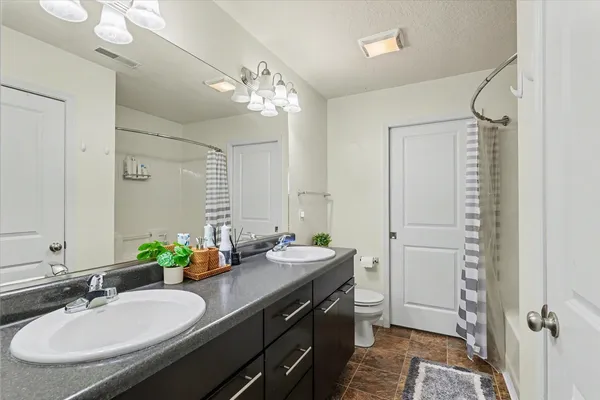a bathroom with a double vanity sink mirror and double