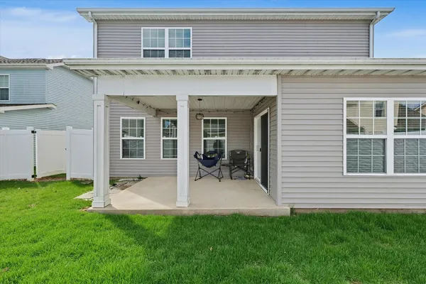 a view of a house with backyard porch and sitting area