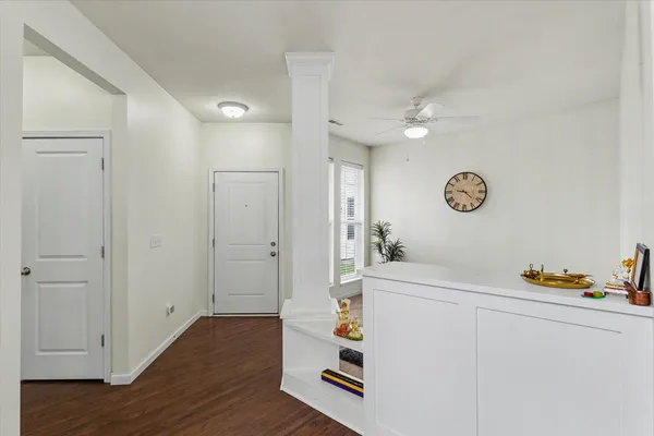 a room with a white cabinets and wooden floor