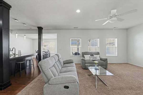 a living room with furniture and wooden floor