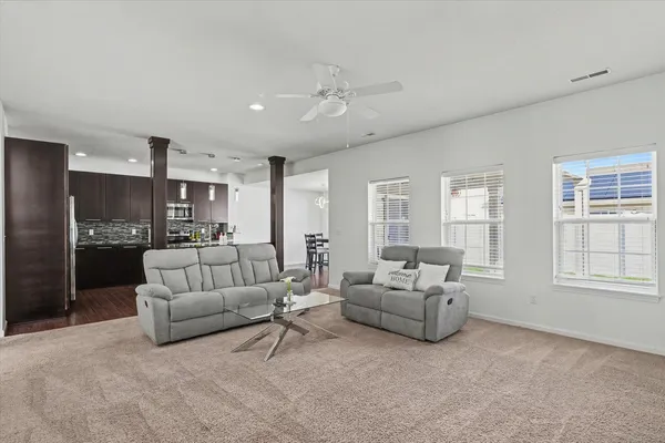 a living room with furniture and a large window