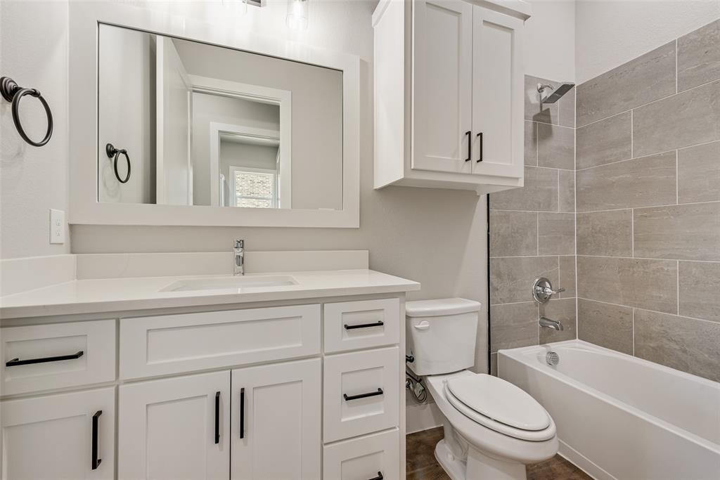1327 Selby Road Van Alstyne, TX 75495 - Photo 23 of 38 a bathroom with a sink a toilet and a bathtub