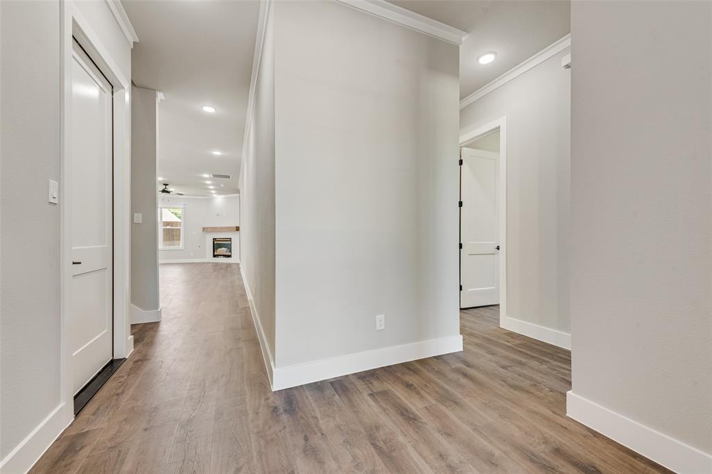 1327 Selby Road Van Alstyne, TX 75495 - Photo 8 of 38 a view of a hallway with wooden floor