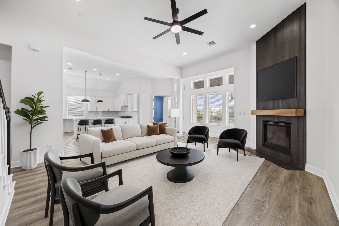 a living room with furniture a fireplace and a flat screen tv