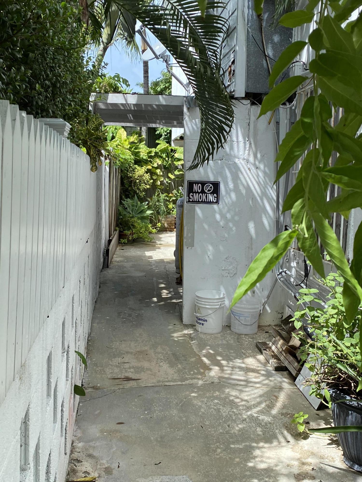 927 Catherine Street Key West, FL 33040 - Photo 12 of 29 a backyard of a house with a tree