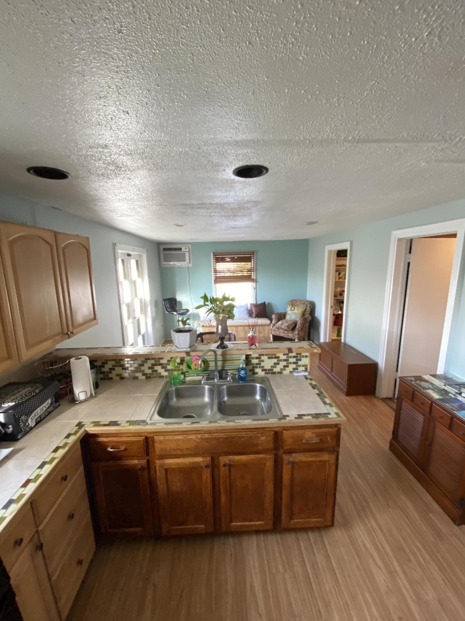 927 Catherine Street Key West, FL 33040 - Photo 19 of 29 a view of living room with granite countertop furniture and wooden floor