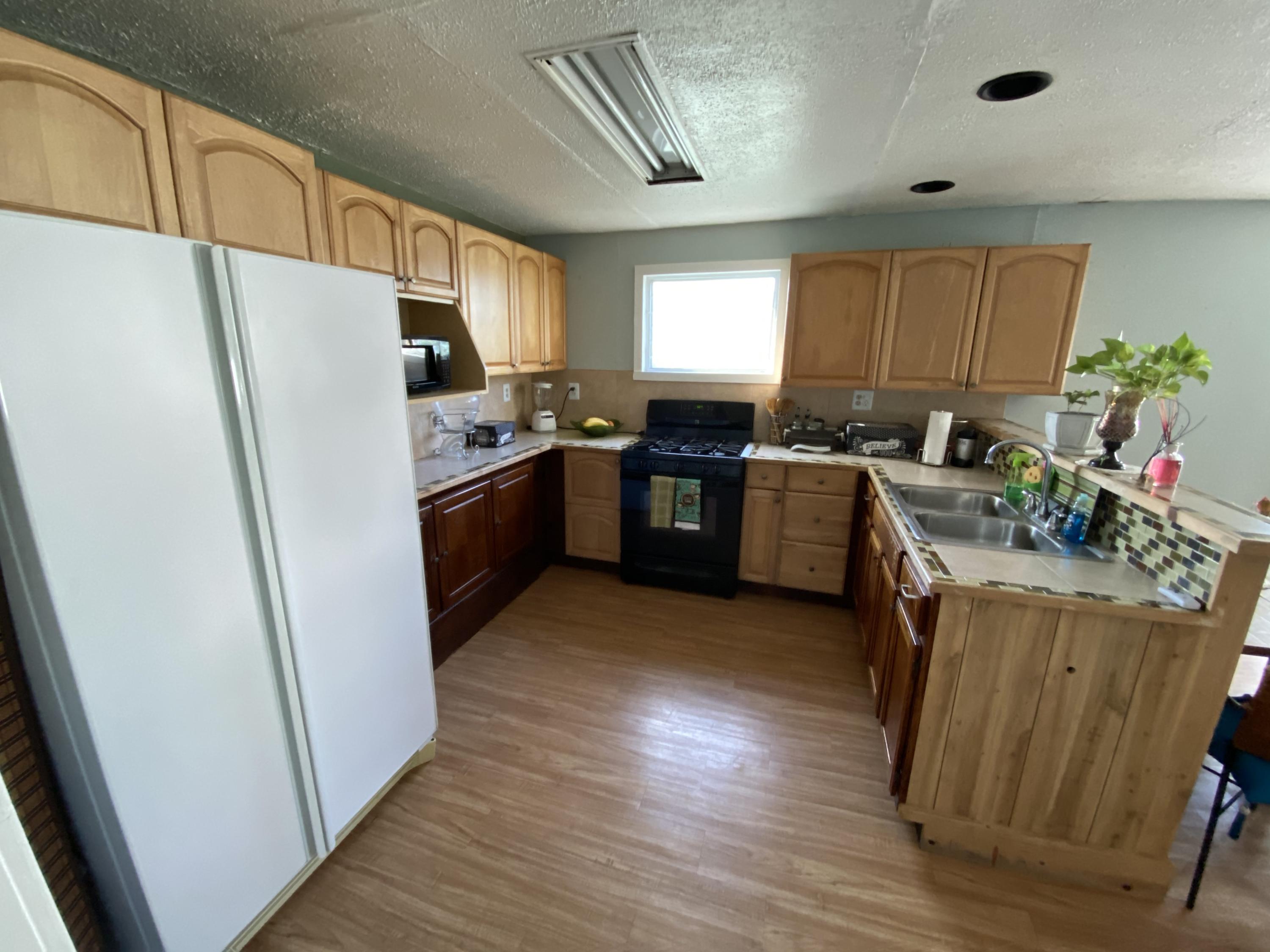 927 Catherine Street Key West, FL 33040 - Photo 21 of 29 a kitchen with a refrigerator and a stove top oven