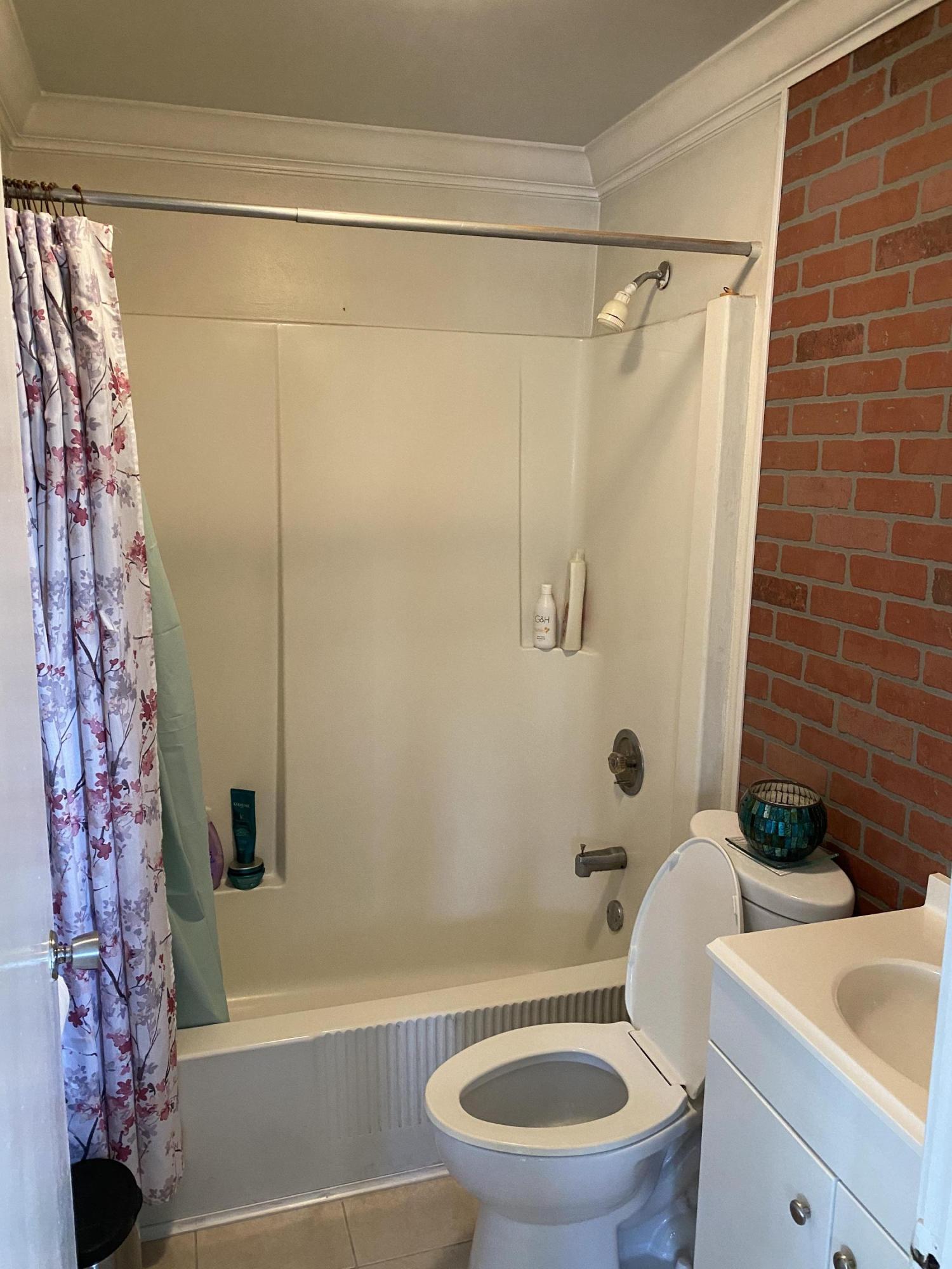 927 Catherine Street Key West, FL 33040 - Photo 23 of 29 a bathroom with a toilet and a shower curtain
