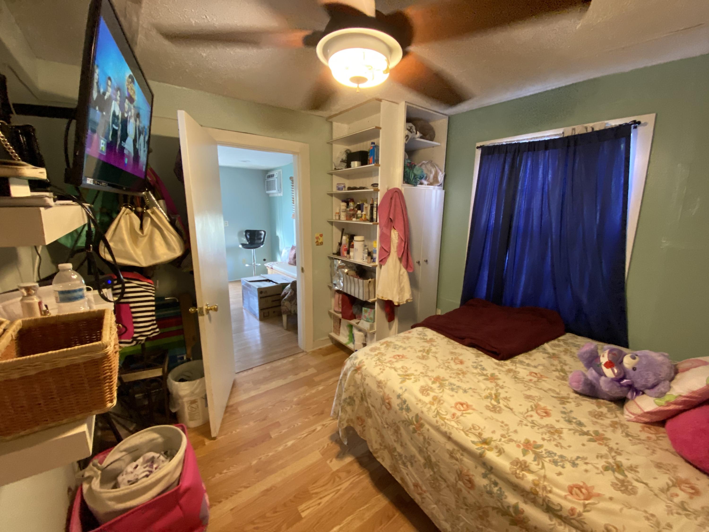 927 Catherine Street Key West, FL 33040 - Photo 27 of 29 a bedroom with a bed and a window