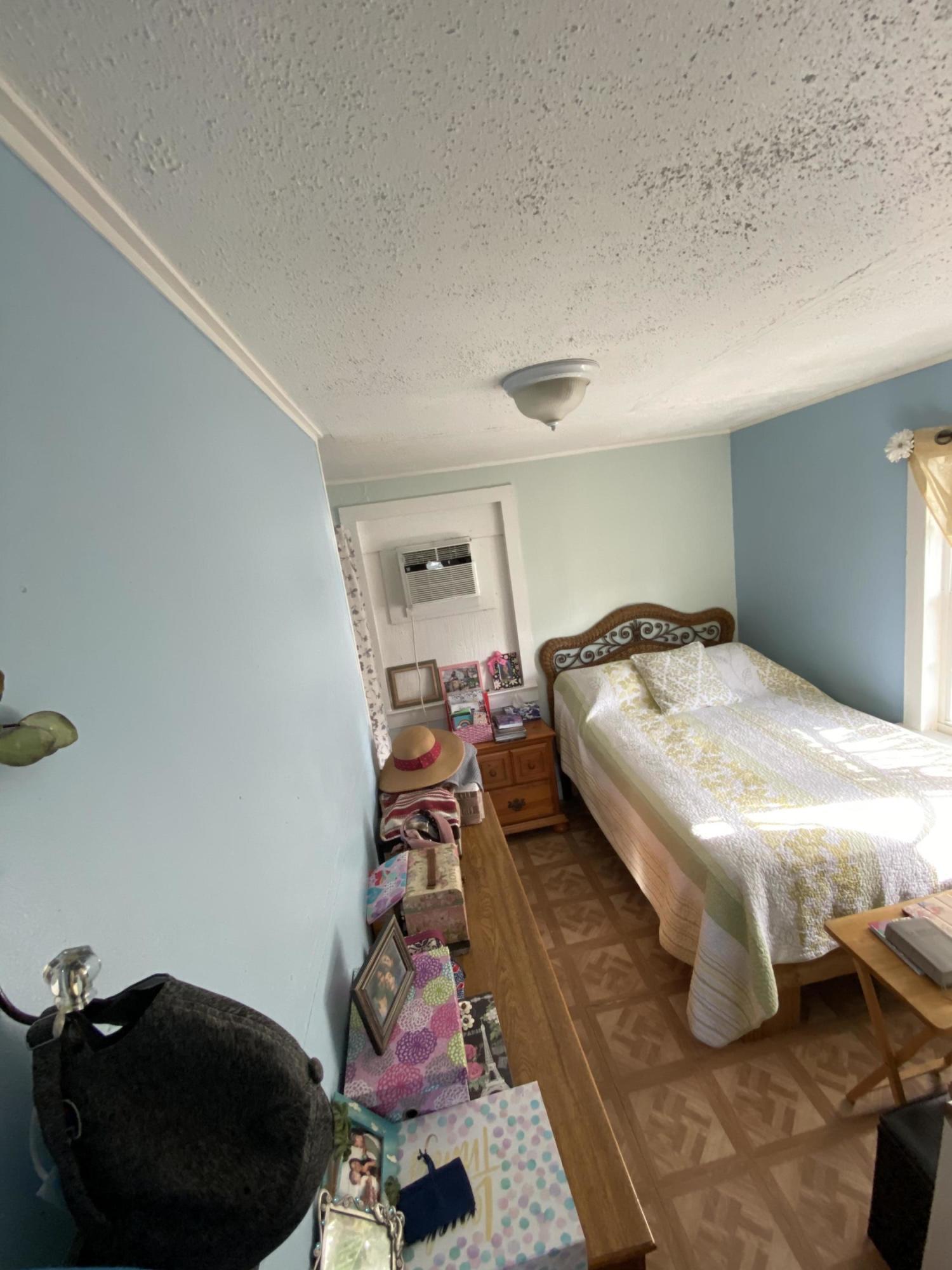 927 Catherine Street Key West, FL 33040 - Photo 29 of 29 a bedroom with furniture and a mirror