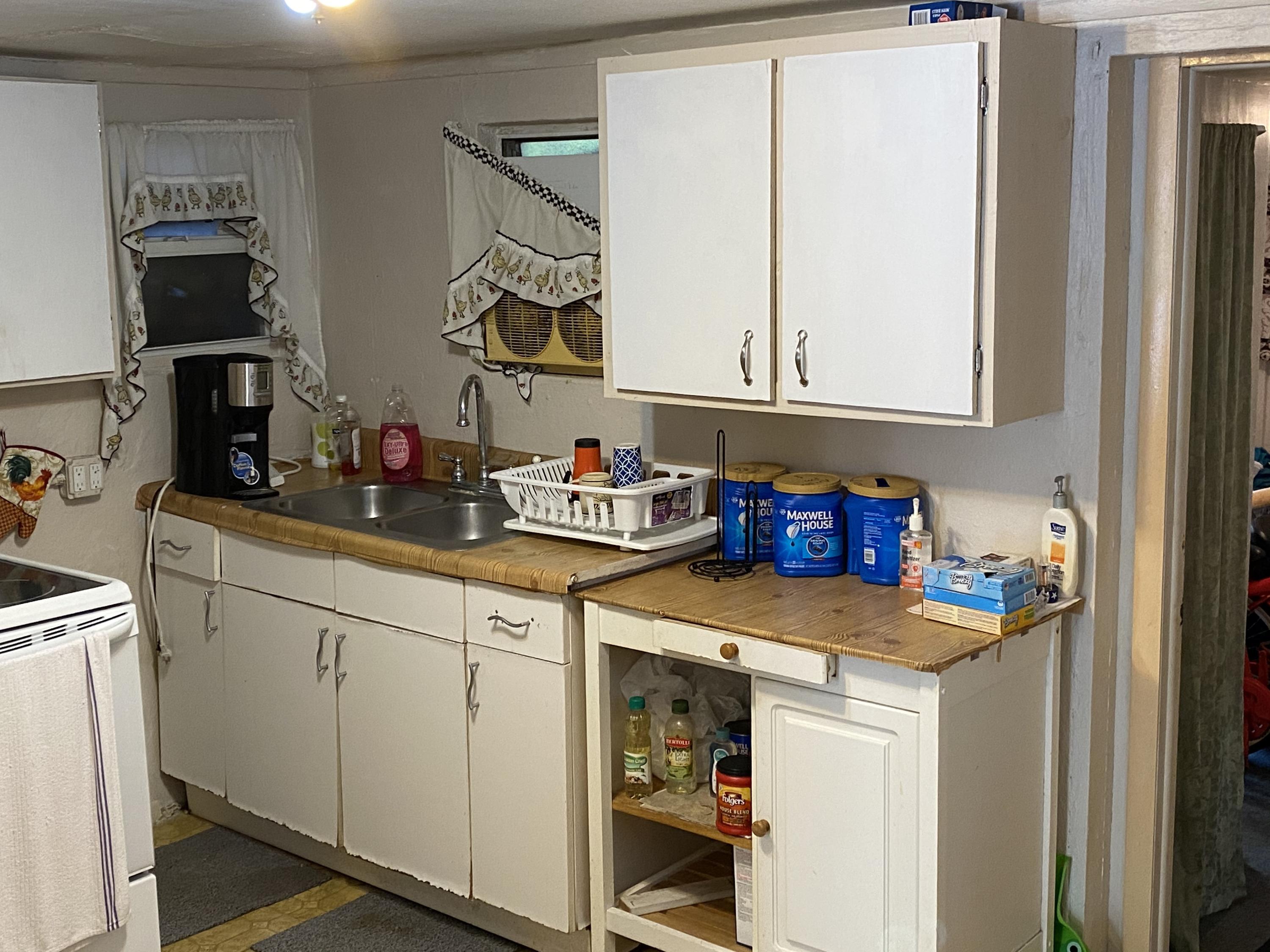 927 Catherine Street Key West, FL 33040 - Photo 6 of 29 a kitchen with sink cabinets and appliances