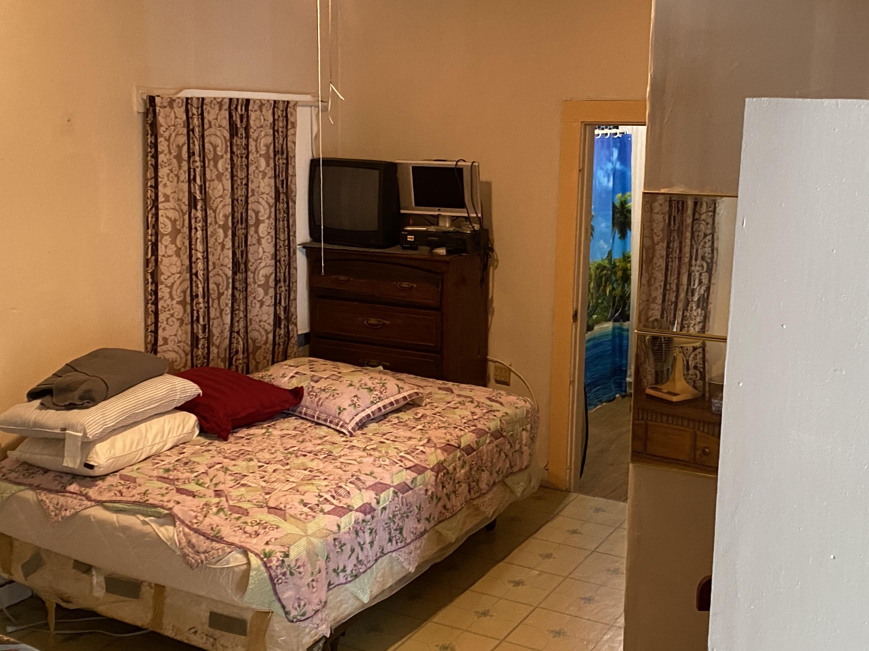 927 Catherine Street Key West, FL 33040 - Photo 9 of 29 a bedroom with a bed and a television