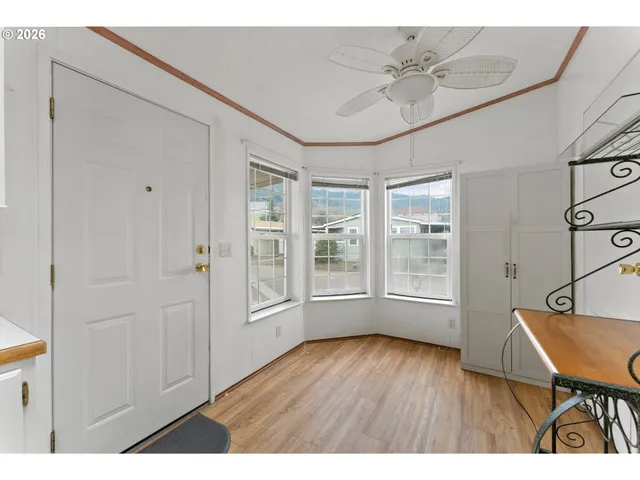 a workspace with wooden floor and a window