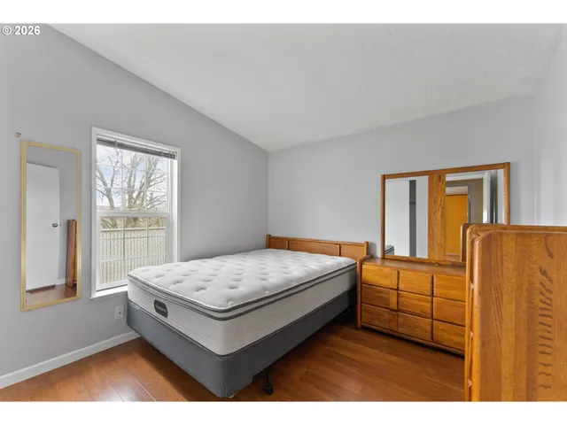 a living room with a bed furniture and next to a window
