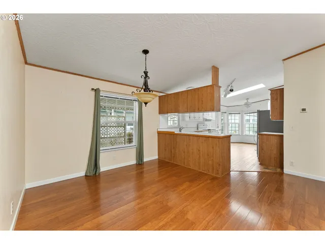 a view of a kitchen with wooden floor