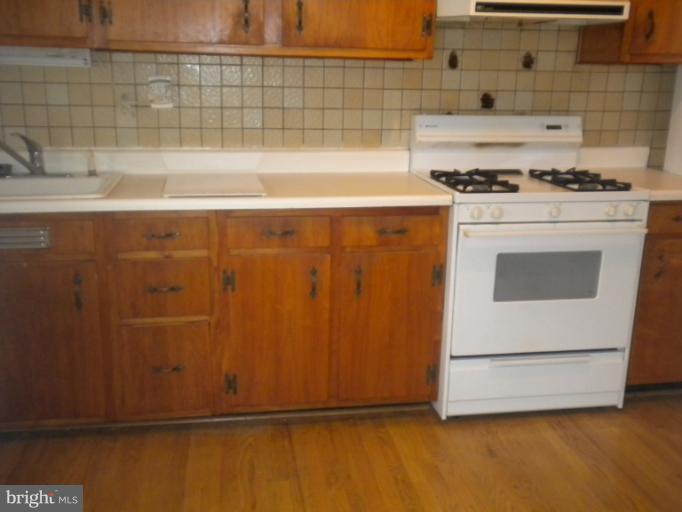 305 Hopkins Road Baltimore, MD 21212 - Photo 11 of 30 a kitchen with granite countertop cabinets and white stove