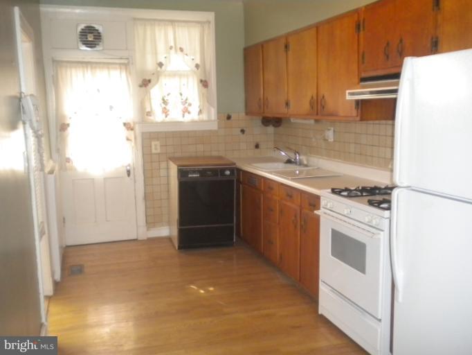 305 Hopkins Road Baltimore, MD 21212 - Photo 13 of 30 a kitchen with stainless steel appliances granite countertop a stove a sink and a refrigerator