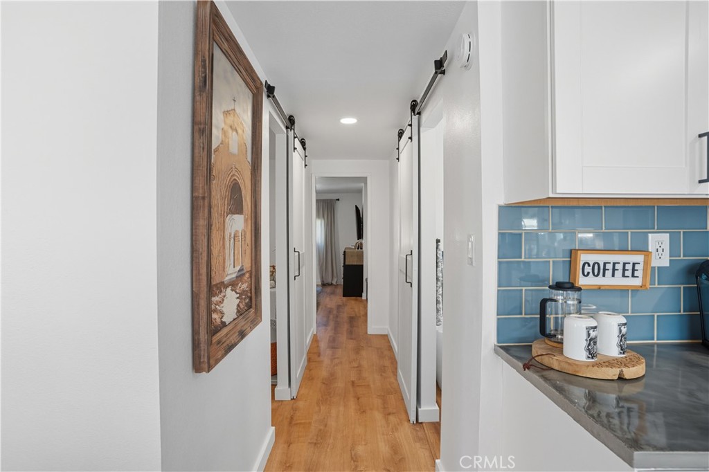1120 East Mission Road, Unit 33 Fallbrook, CA 92028 - Photo 17 of 47 a view of a hallway with wooden floor and cabinet