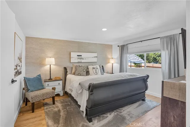 a bedroom with a bed and a mirror