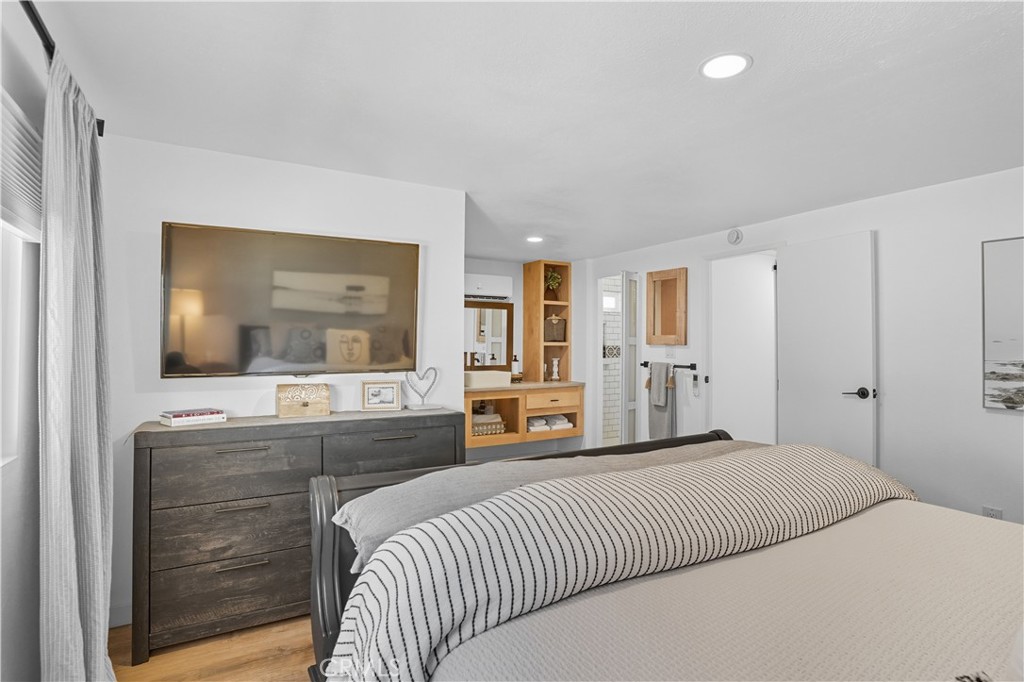 1120 East Mission Road, Unit 33 Fallbrook, CA 92028 - Photo 19 of 47 a bedroom with a bed and a mirror