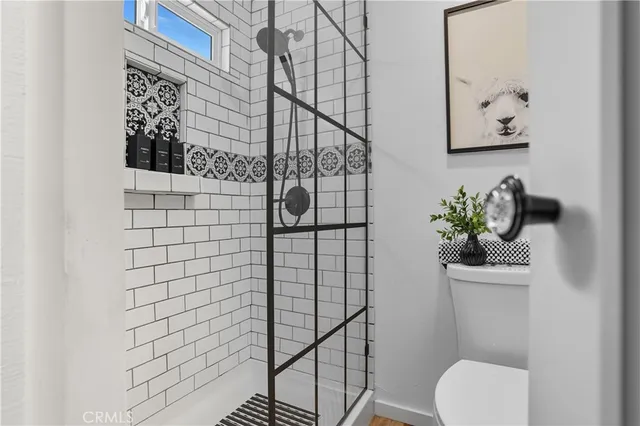 a white toilet sitting next to a shower curtain