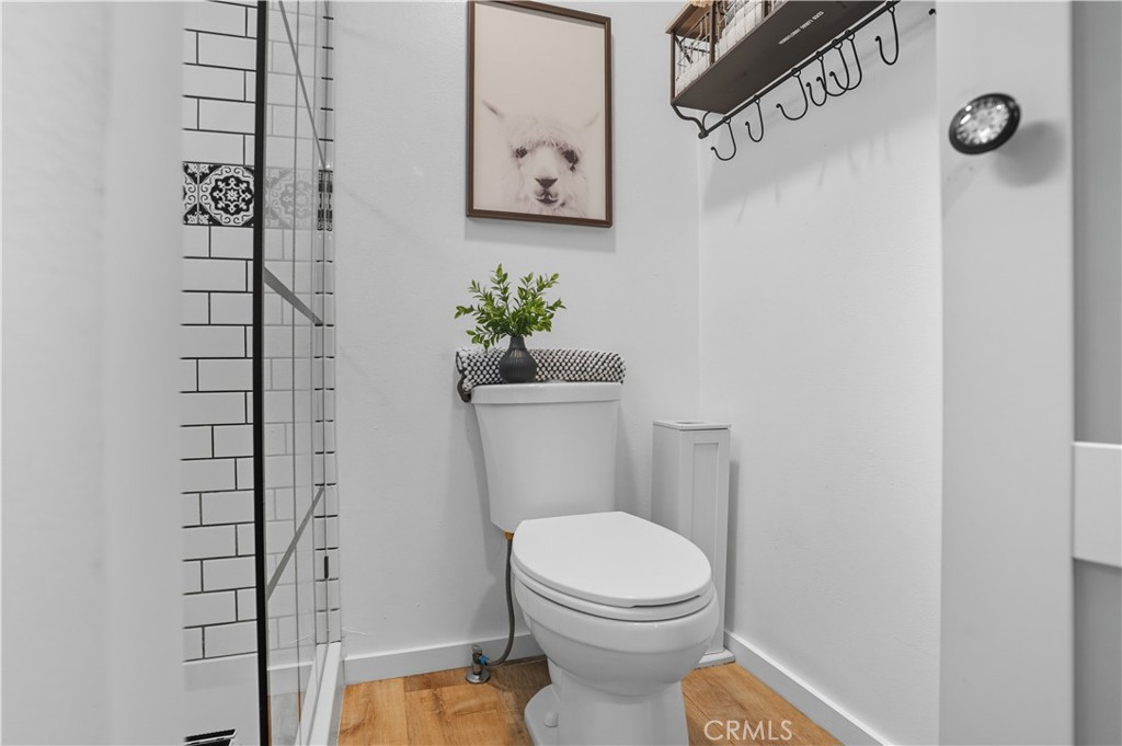 1120 East Mission Road, Unit 33 Fallbrook, CA 92028 - Photo 22 of 47 a white toilet sitting next to a shower curtain