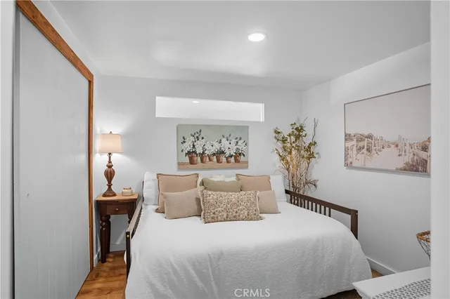 a bedroom with a bed and ceiling fan