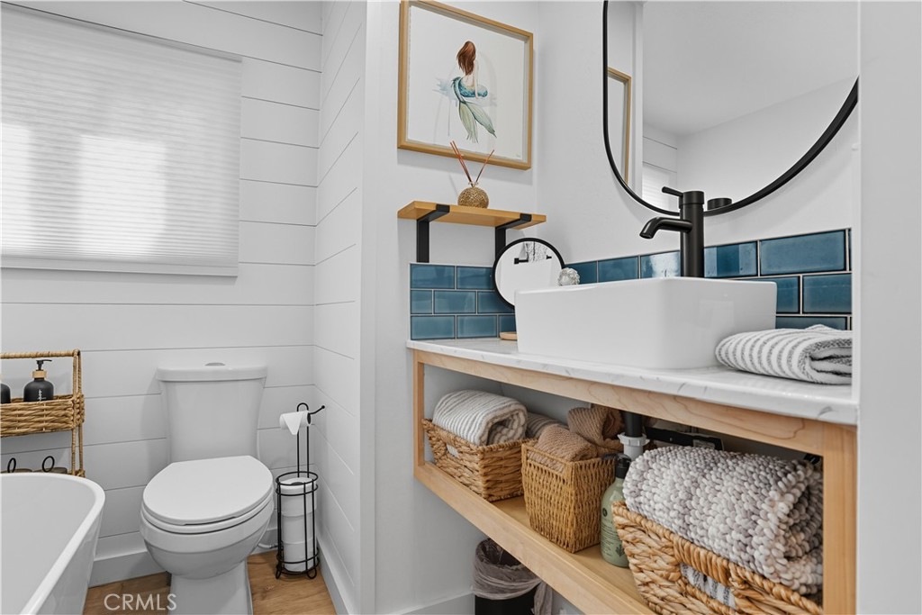 1120 East Mission Road, Unit 33 Fallbrook, CA 92028 - Photo 27 of 47 a bathroom with a toilet a sink and mirror