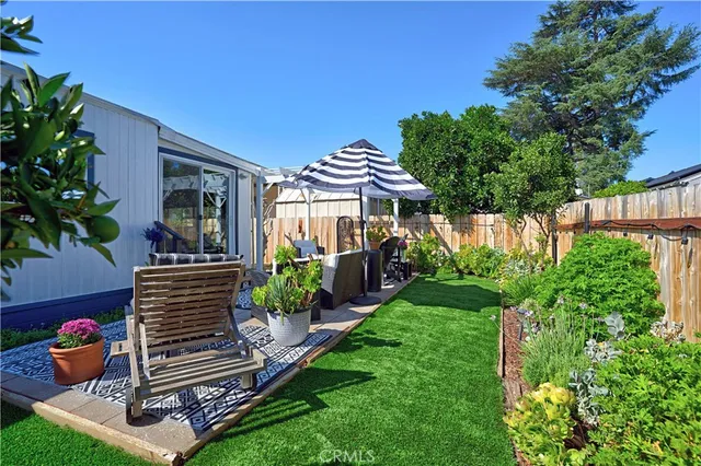 a view of a patio with couches table and chairs and potted plants