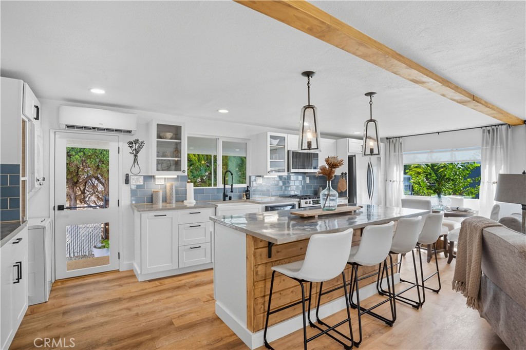 1120 East Mission Road, Unit 33 Fallbrook, CA 92028 - Photo 4 of 47 a kitchen with stainless steel appliances kitchen island granite countertop a stove a sink and a refrigerator