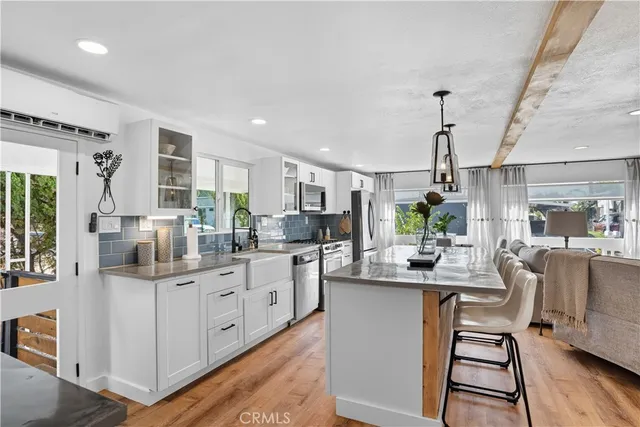a kitchen with granite countertop a sink stove and cabinets