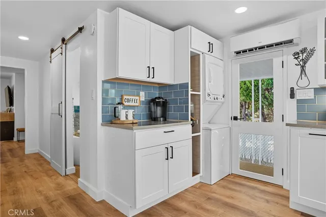 a kitchen with white cabinets and refrigerator