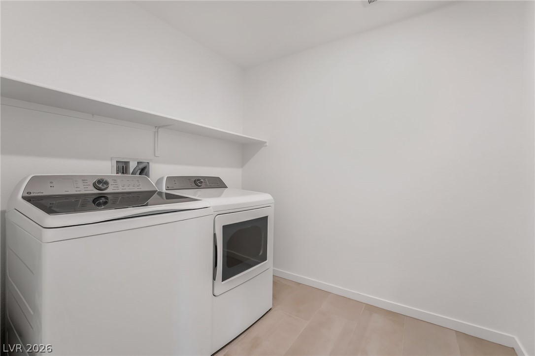 894 Cadence View Way Henderson, NV 89011 - Photo 23 of 23 A well-organized laundry room offers convenience and dedicated space for chores.