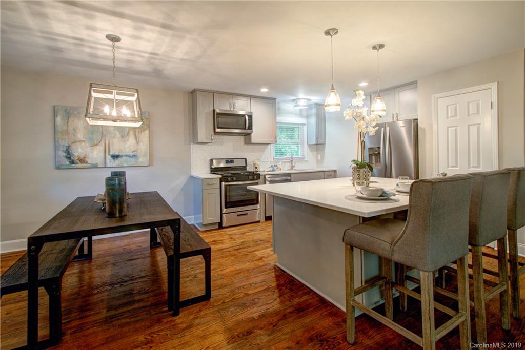 7439 Watercrest Road Charlotte, NC 28210 - Photo 2 of 28 a view of a dining room with furniture and wooden floor